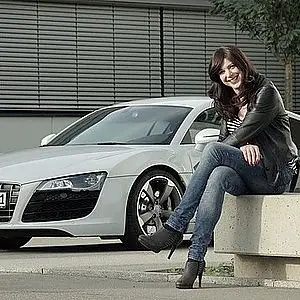 Photo of business woman near an imported car